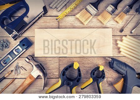 Set Of Construction Tools On A White Wooden Plank, Directly Above. Copy Space For Your Text.