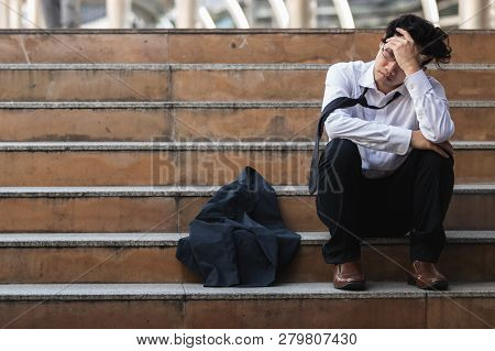Unemployed Stressed Young Asian Business Man In Suit Covering Face With Hands. Failure And Layoff Co