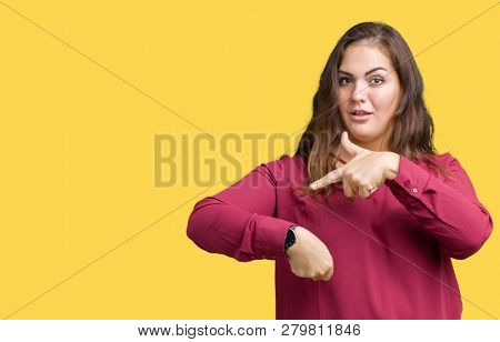 Beautiful plus size young woman over isolated background In hurry pointing to watch time, impatience, upset and angry for deadline delay