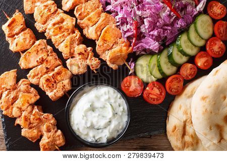 Lebanese Shish Taouk (tawook)with Fresh Vegetables, Yogurt Sauce And Pita Close-up. Horizontal Top V