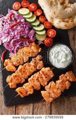 Traditional Taouk Chicken Kebab With Fresh Salad, Yogurt Sauce And Pita Bread Close-up. Vertical Top