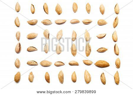 A Collection Of Peeled Almonds Badam Lie In Horizontal Rows On An Isolated White Background. With Cl