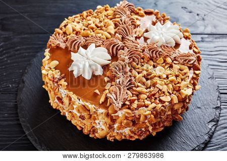 Peanut Cake Topped With Cocoa Peanut Butter Cream And Egg Whites Roses On A Stone Plate On A Wooden 