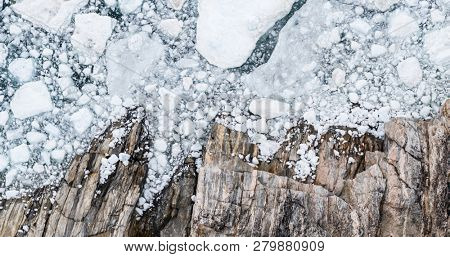 Climate Change and Global Warming - Icebergs drone aerial image top view. Icebergs from melting glacier in icefjord in Ilulissat, Greenland. Arctic nature ice landscape in Unesco World Heritage Site.