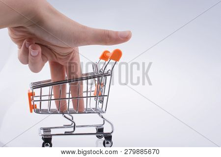 Hand Holding A Cart On A White Background