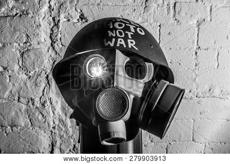 Art Picture Of A Military Gas Mask On A White Brick Wall With Shadows With Flash With The Inscriptio