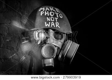 Art Picture Of A Military Gas Mask On A White Brick Wall With Shadows With Flash With The Inscriptio