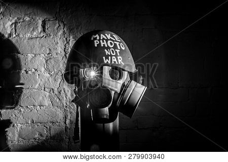 Art Picture Of A Military Gas Mask On A White Brick Wall With Shadows With Flash With The Inscriptio