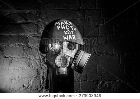 Art Picture Of A Military Gas Mask On A White Brick Wall With Shadows With Flash With The Inscriptio