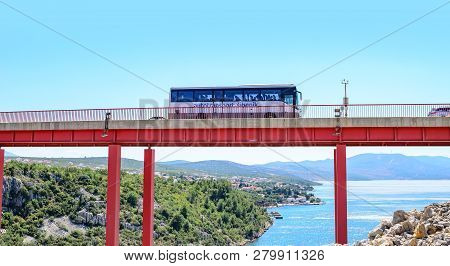 Zadar, Croatia - July 16, 2017: Bus Rides Over The Bridge Located Above The Sea Bay On A Summer Day,