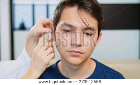 A Young Guy Wearing A Hearing Aid.