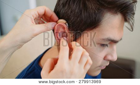 A Young Guy Wearing A Hearing Aid.
