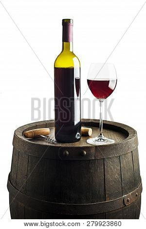 Glass And Bottle Of Red Wine On Wooden Barrel Background