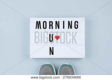 Motivation Text On Light Box Morning Run And Sports Shoes On Gray Background, Flat Lay, Top View. Mi
