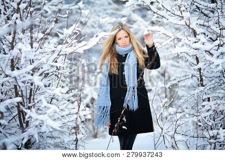 Beautiful Young Girl Smiling And Walking In The Street. Beautiful Snowy Cold Winter. Holiday Mood.