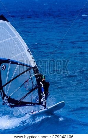Malaga, Spain - May 25, 2018 Windsurfer Practicing Active Water Sport In The Bay Of Malaga, A Place