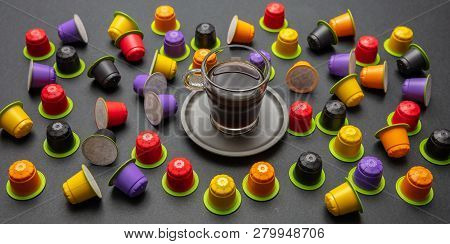 Coffee Cup And Compostable Capsules, On Black Color Background