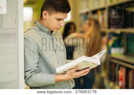 Boy Student In Library Want To Find Some Book. He Read The Book. Heplful Information. Study