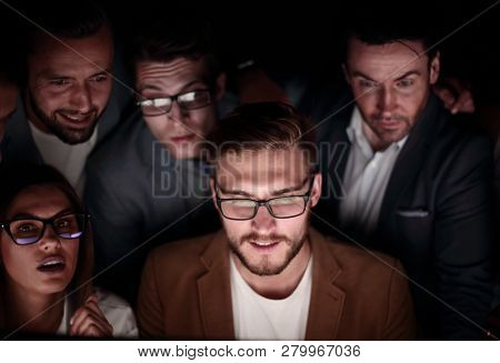 close up.a group of employees working in the office late