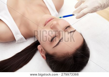 Woman Gets Injection In Her Face. Beauty Woman Giving Injections. Young Woman Gets Beauty Facial Inj