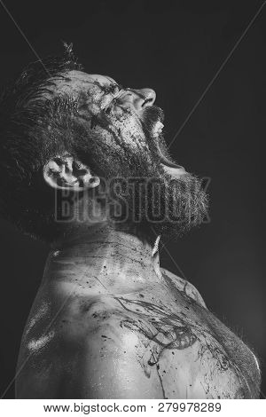 Bearded Hipster With Red Blood On Face, Tattooed Chest. Man With Beard Shout With Anger On Black Bac