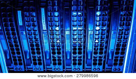 close-up of Data center with hard drives in a row, blue tint