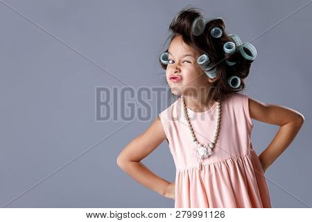 Cute Little Child Girl In Pink Dress And Hair Curlers