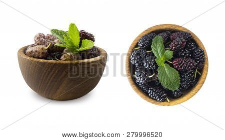 Mulberries In A Wooden Bowl With Copy Space For Text. Black And Purple Mulberry On White Background.