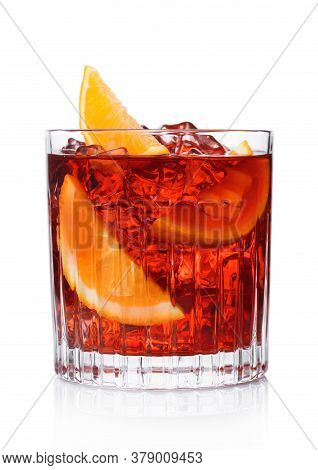 Negroni Cocktail In Crystal Glass With Ice Cubes And Orange Slices On White Background