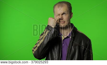 Funny Stupid Rocker Man In Jacket Picking Nose With Silly Brainless Humorous Expression, Removing Bo