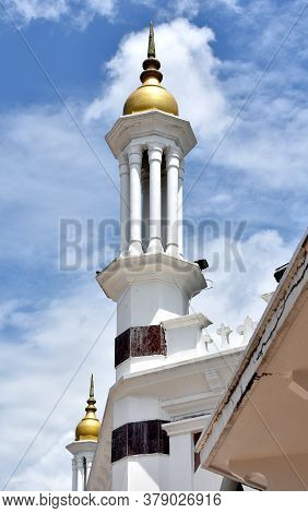 Minaret With A Golden Dome At Ubudiah Royal Mosque In Malaysia
