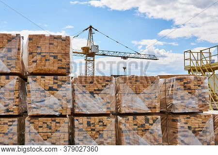 Packaged Freshly Made Boards And Cranes In The Background In The Yard Of The Woodworking Production