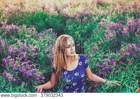 European Blonde Young Slim Girl Walks On Tall Grass