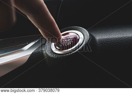Car Driver Press To The Engine Start Stop Button For Engine Ignition In A Luxury Car.
