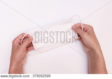 Hands Holding White Protective Surgical Medical Face Mask On White Background, Ppe Personal Protecti