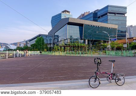 Geoje, South Korea - June 15, 2017: Brompton Folding Bike Parks On The Street Across Dsme Shipbuilde