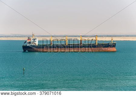 Suez, Egypt - November 14, 2019: Bulk Carrier Vessel Vega Tauru Is At Anchor In Suez Canal In Egypt.