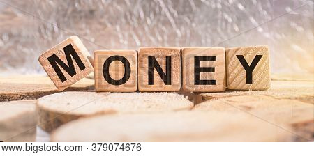 Wooden Blocks With The Word Money. Business And Finance Concept.