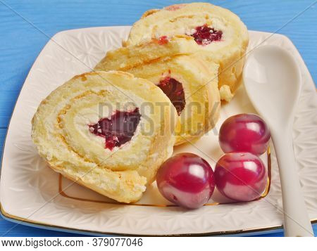 Cream Buns On A Plate With Cherries, On A White Saucer, On A Blue Background. Proper Nutrition. Life