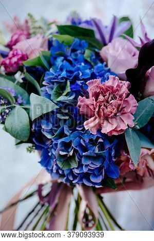 Close-up Bouquet Of Of Flowers On A Light Background. Bouquet Of Eucalyptus, Carnation, Hydrangea, R