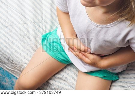 Abdominal Pain In A Preschool Child. Poisoning In Children. The Boy Holds His Hands To The Abdominal