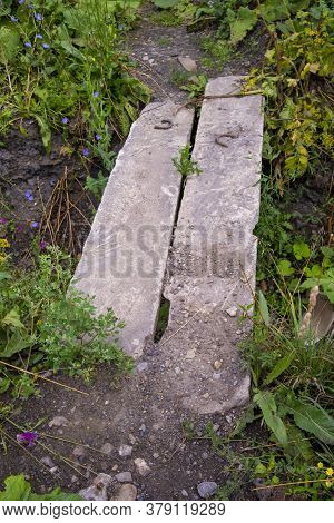 Bridge Of Two Concrete Blocks Across A Shallow Ditch