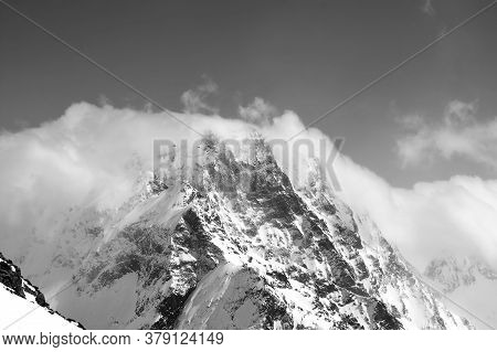 High Snowy Rocky Mountains In Clouds And Fog. Caucasus Mountains At Winter, Region Dombay, Mount Dom