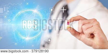 Close-up of a doctor giving you a pill with RDS abbreviation, virology concept