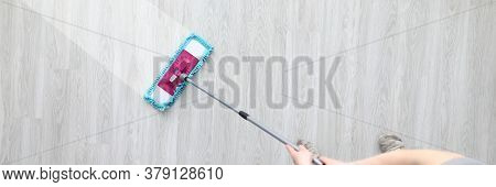 Male Hant Hold Plastic Mop And Wash Dirty Ploor Closeup Background. Professional Cleaning Concept