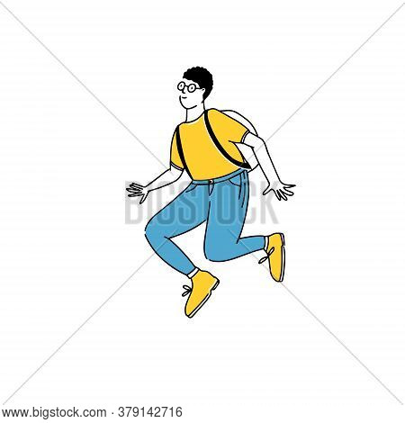 Jumping Young Man In Round Glasses, Yellow Tee And Blue Jeans. Student Up In The Air. Cheerful Guy C