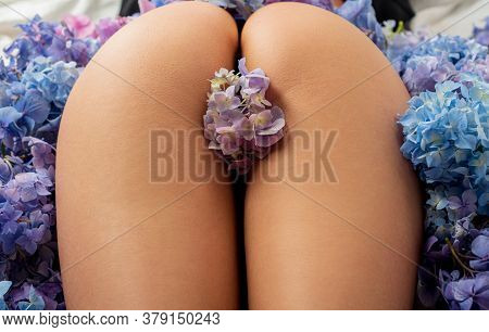 Naked Woman Buttocks. Ideal Womans Ass. Sensual Seductive Young Womans Butt In Flovers