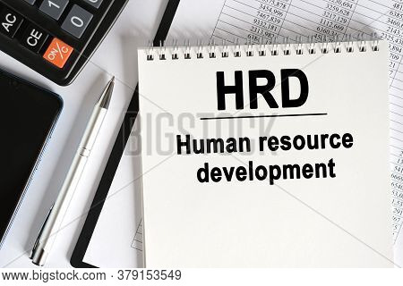 On The Table Lies A Smartphone, A Calculator And A Notebook With The Inscription- Hrd. Human Resourc