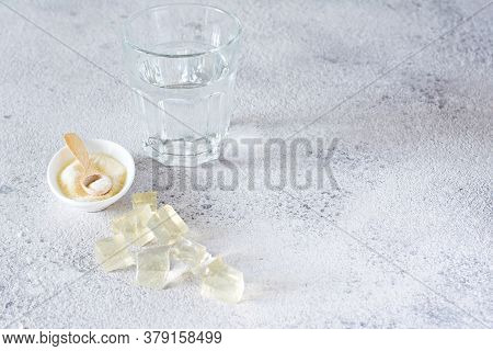 Gelatin, Agar-agar, Gelatinous Mass (cubes In The Form Of Crystals) On A Gray Background. Gelling Ag