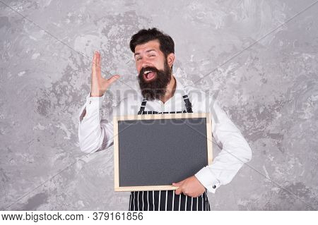 Man Good Looking Hospitable Restaurant Waiter With Blackboard Copy Space, Meal Of The Day Concept.